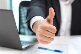 Business man showing thumbs up in office. © terovesalainen / Fotolia